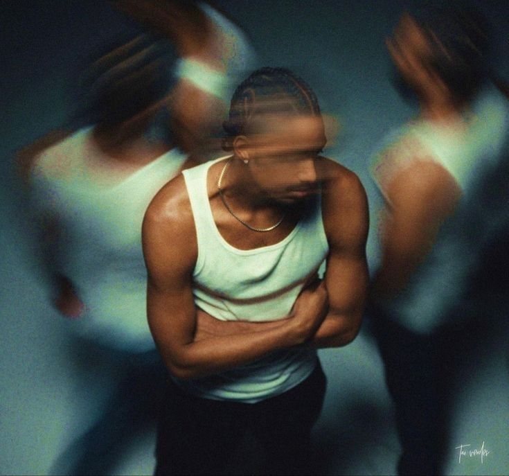 Portrait in a white tank top surrounded by motion-blurred figures.