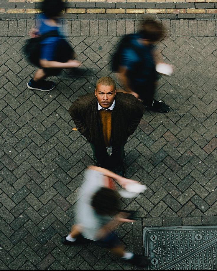 Overhead street portrait surrounded by passing pedestrians.